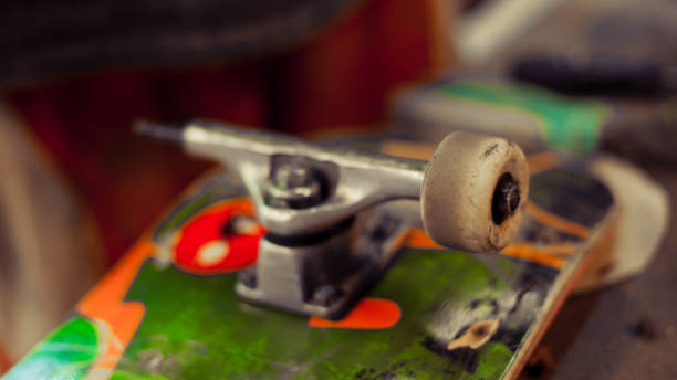 istock Young man in carpentry workshop fixing wheel on his skateboard 853970410