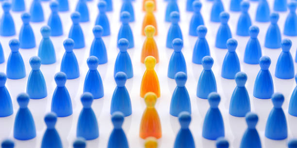 istock Yellow Pawns Standing Out From The Crowd 853972846