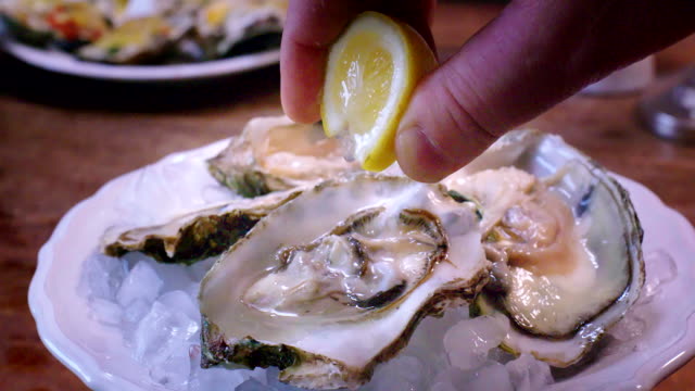 Oysters on plate with ice and lemon