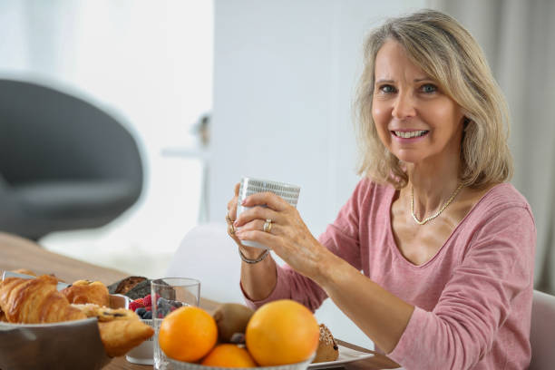 istock senior woman having french breakfast 853973834