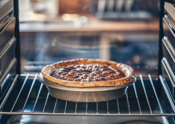 istock Baking Pecan Pie in The Oven for Holidays 853981384