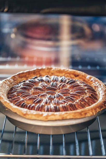 istock Baking Pecan Pie in The Oven for Holidays 853981402
