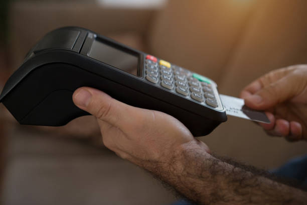 istock Close up of man using payment terminal paying 853981588