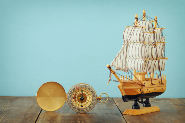 istock Columbus day concept with old ship over wooden background 853982554