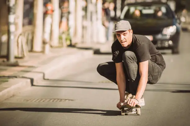 Photo of Two skateboarders ride a skateboard slope in the city street