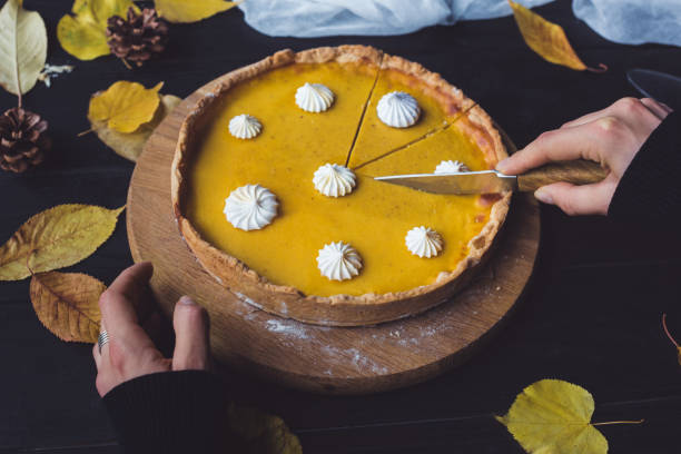 istock Female hands cutting pumpkin pie 853983116