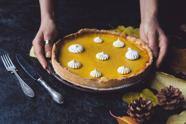 istock female hands placing pie on counter 853983656