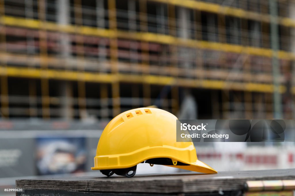 Yellow safety hardhat. Side view Construction Site Stock Photo