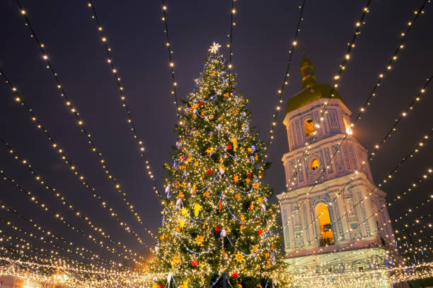 Christmas tree with lights outdoors at night in Kiev Sophia Cathedral on background. New Year Celebration new year urban scene horizontal people stock pictures, royalty-free photos & images