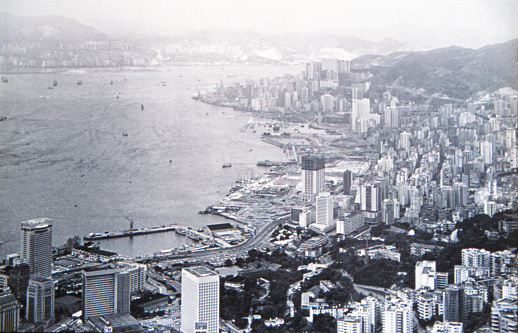 Historic photo of the British Colonial Hong Kong. Circa 1971. The view from Victoria Peak of the skyline of the island of Hong Kong, the Victoria Harbor and the Kowloon peninsula in the background.