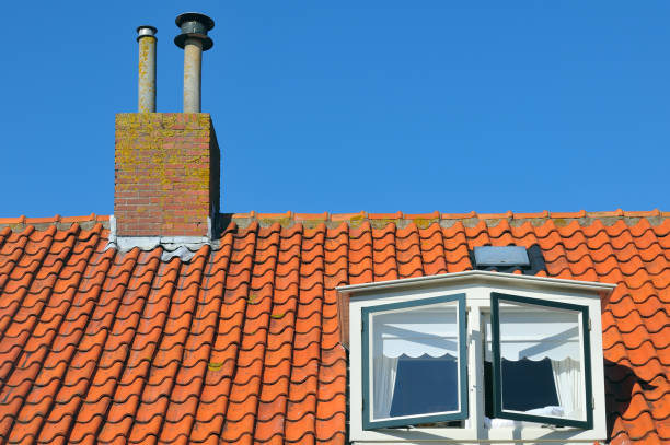 istock Red tiled roof with a windows and chimney 853998370