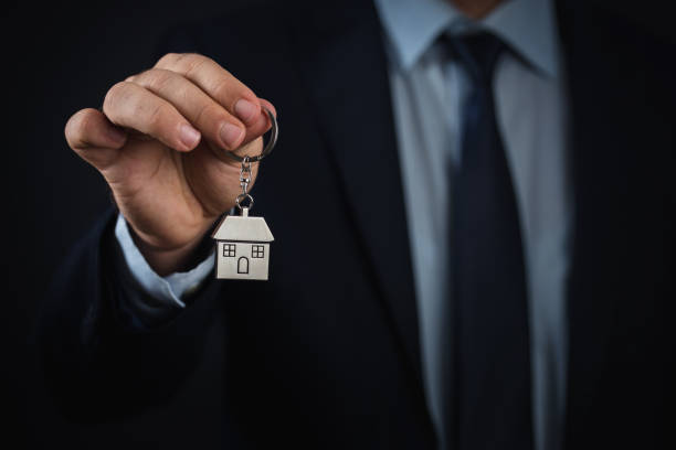 istock House key in businessman hand with clipping path 854001090