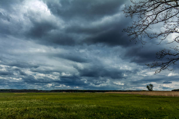 istock Dark rainy clouds over the field in countryside 854002118
