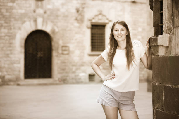 istock Romantic girl leaning against stone wall 854010090