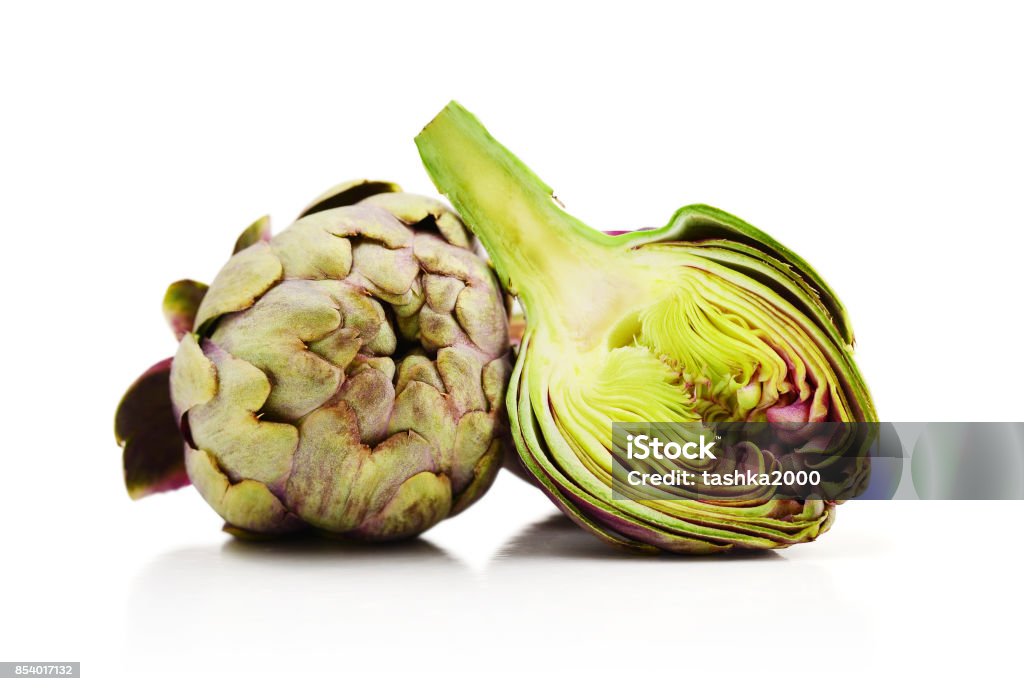 Two fresh artichokes Two fresh artichokes with stem and a half showing the heart isolated on white background with clipping path Artichoke Stock Photo