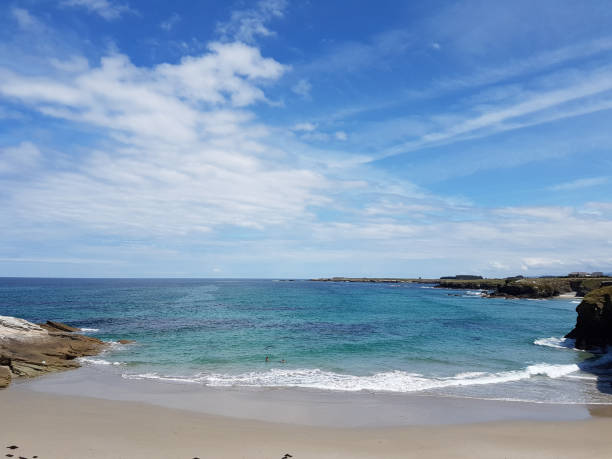 istock sunny sky at rock beach in Galicia 854018592