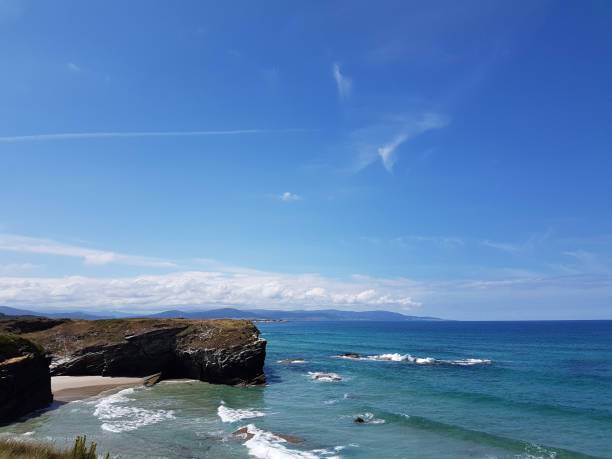 istock sunny sky at rock beach in Galicia 854018626