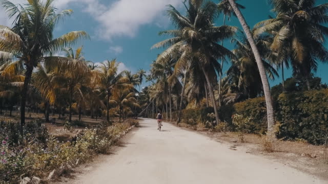 Young adult woman cycling in Seychelles