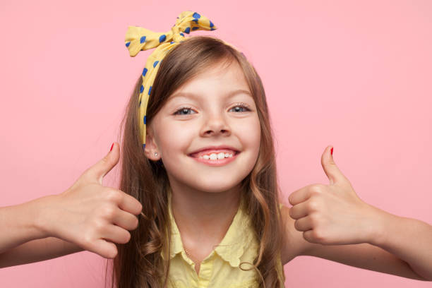 istock Smiling girl holding thumbs up 854033842