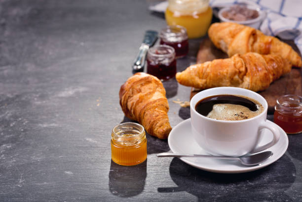 istock cup of coffee and croissants with fruit jam 854034546