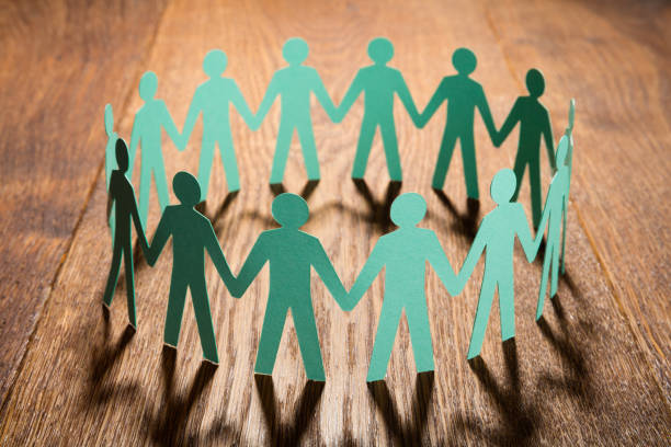 istock Cut Out Of Paper Holding Hands Together 854038454