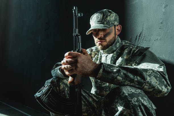 istock soldier in military uniform with rifle 854038950