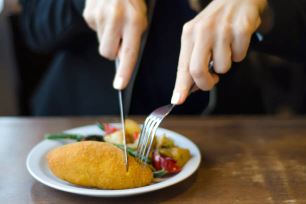 istock Vegetable stew and chicken cutlet female hands 854043822