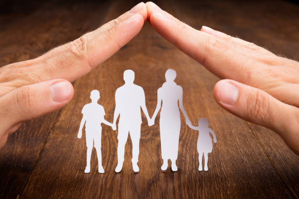 istock Person Hand Protecting Family Papercut 854043932