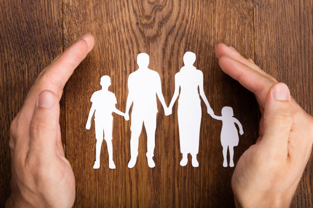 istock Person Hand Protecting Family Papercut 854045478