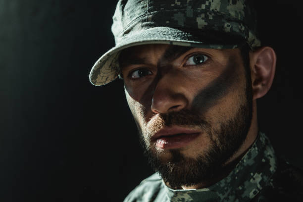 istock soldier with camouflage on face 854047784