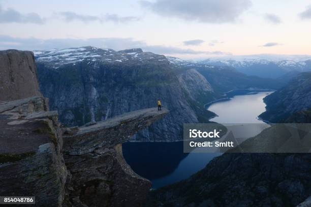 Alone Tourist On Trolltunga Rock Stock Photo - Download Image Now - Norway, One Person, Landscape - Scenery