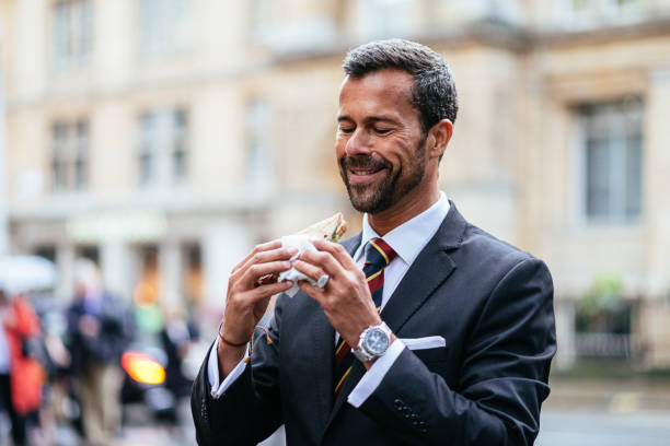 istock Businessman eating sandwich in London downtown 854052022