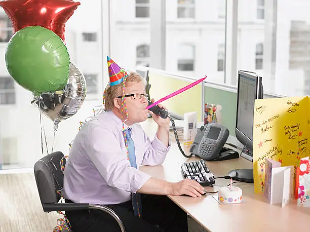 Photo of Businessman having birthday party at desk