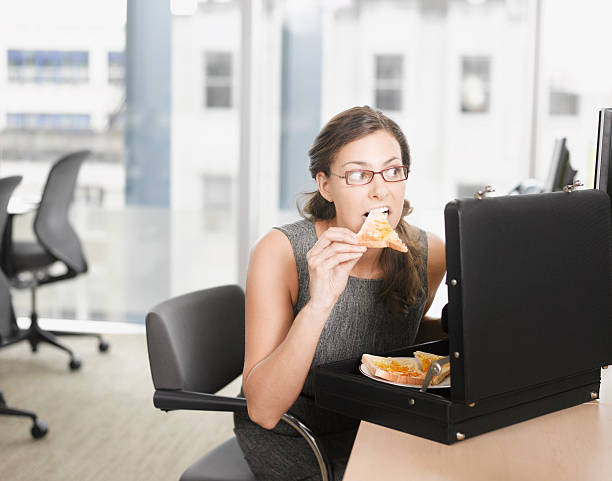 деловая женщина ест пицца от портфель - business person suspicion clothing well dressed стоковые фото и изображения
