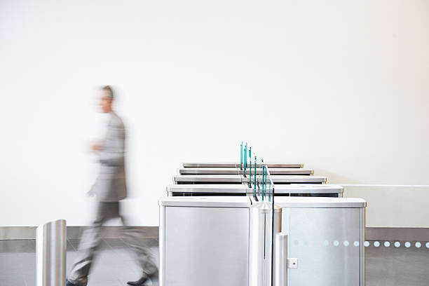 Businessman walking through turnstile  office leave stock pictures, royalty-free photos & images