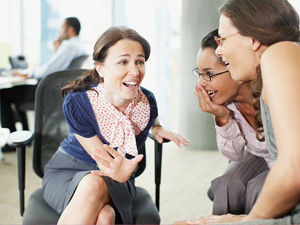 Businesswomen gossiping in office  gossip stock pictures, royalty-free photos & images