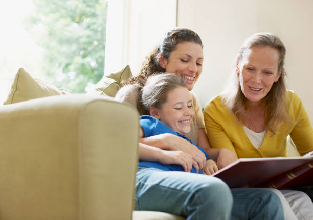 famille regardant un album photo - family album photos et images de collection