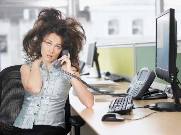 Frazzled businesswoman talking on telephone  waiting telephone on the phone frustration stock pictures, royalty-free photos & images