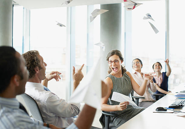 Businesspeople throwing paper airplanes in office  paper airplane photos stock pictures, royalty-free photos & images