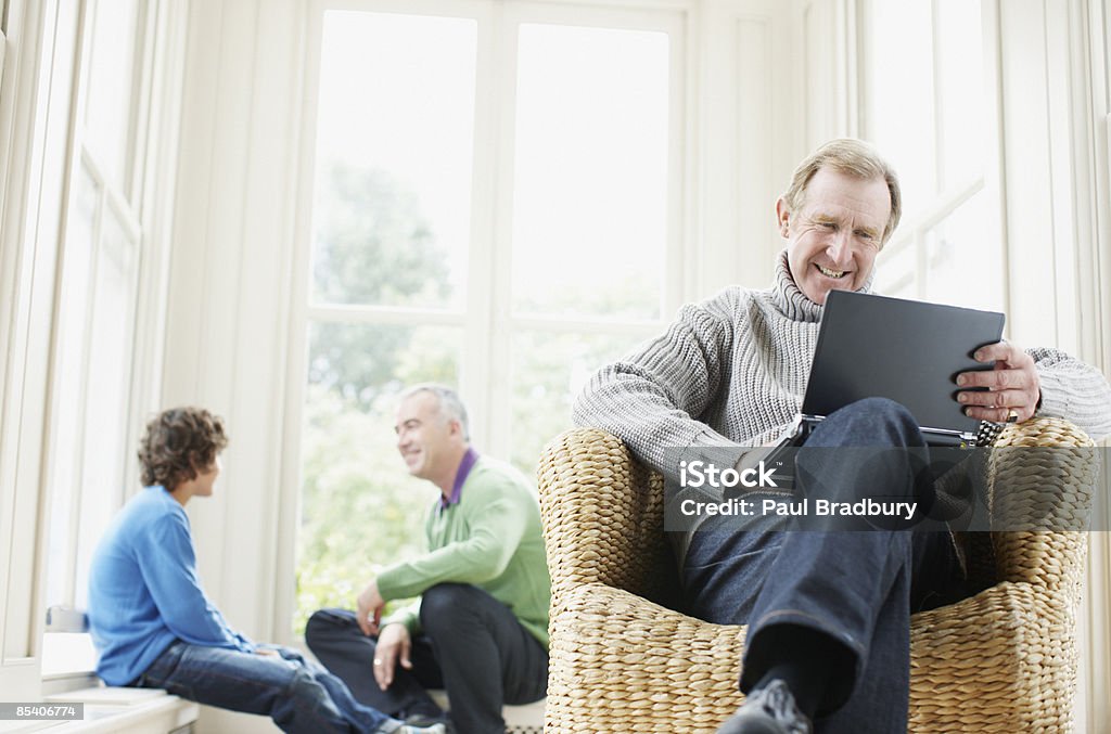 Senior man typing on laptop  Family Stock Photo