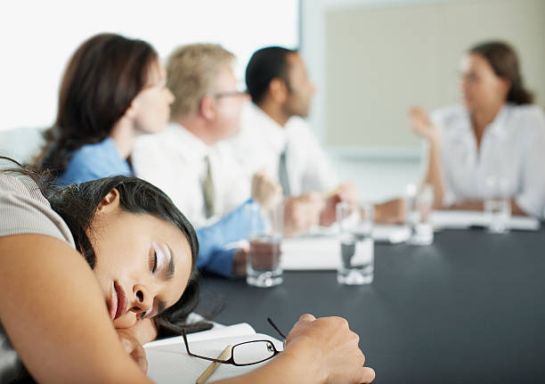 mulher de negócios de deitar, durante uma reunião na sala de conferência - asleep on the job imagens e fotografias de stock