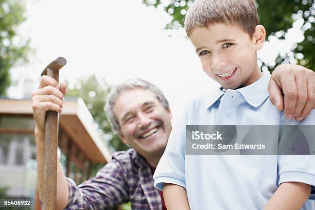 Grandfather And Grandson Gardening Stock Photo - Download Image Now - 55-59 Years, 6-7 Years, Adult