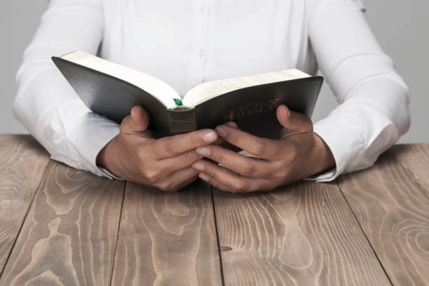 istock Woman hands and Holy Bible 854077736