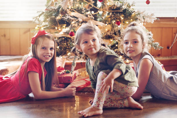istock Holiday Season : Kids around the christmas tree 854077902