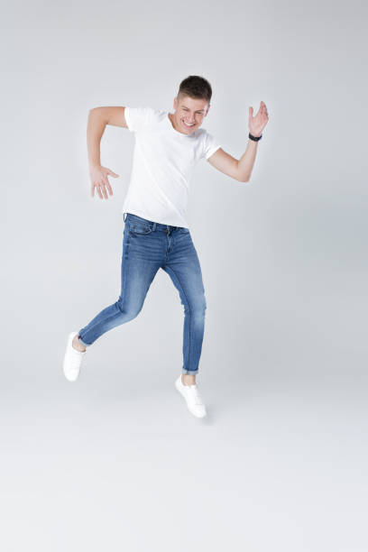 istock handsome man in jeans and jacket jumping 854078550