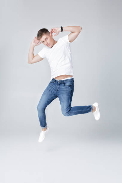 istock handsome man in jeans and jacket jumping 854078678