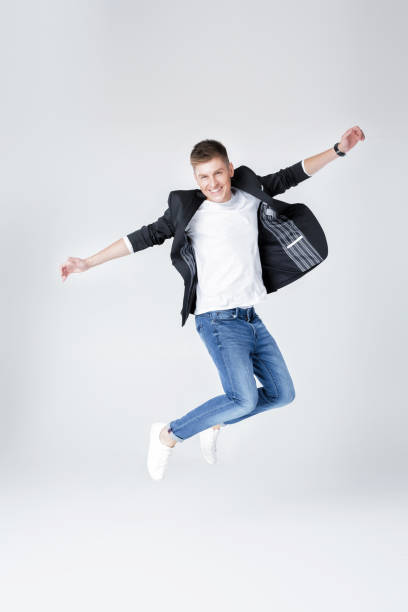 istock handsome man in jeans and jacket jumping 854078842