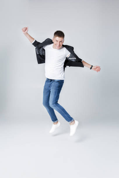 istock handsome man in jeans and jacket jumping 854079052