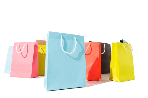 close-up view of colorful shopping bags isolated on white