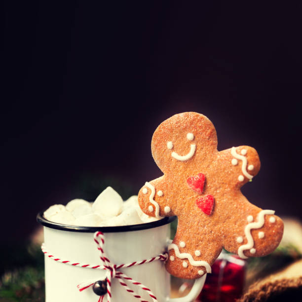istock Hot chocolate with marshmallow   with Christmas gift, gingerbread man cookie, fir tree branches, xmas holiday decorations and festive symbols 854090006